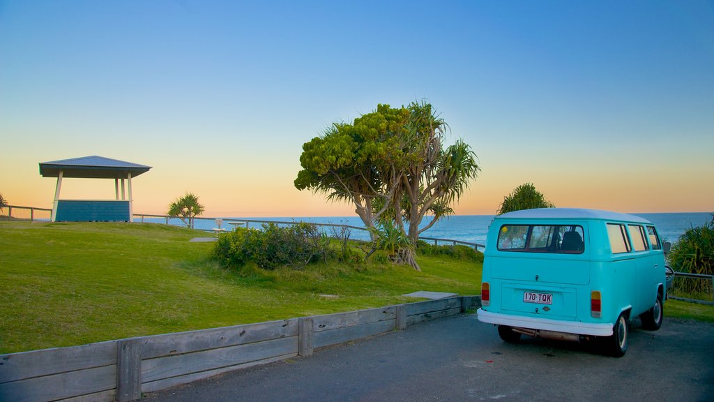 Coolum Beach featuring general coastal views, vehicle touring and a sunset