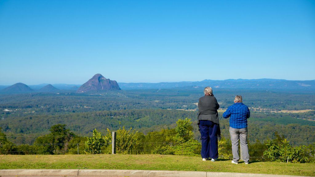 Glasshouse Mountains National Park featuring tranquil scenes and landscape views as well as a couple