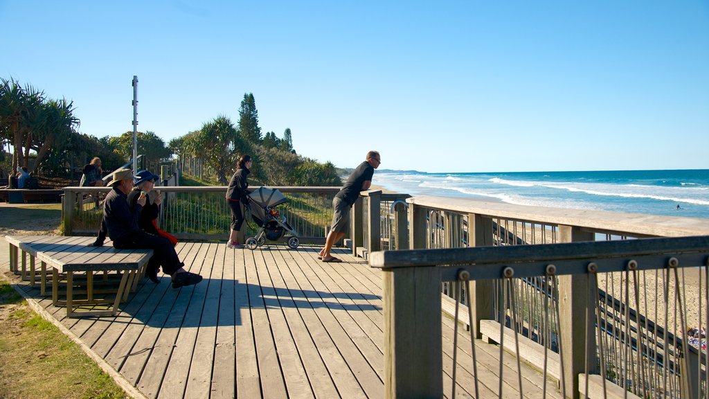 Coolum Beach which includes views and a sandy beach as well as a small group of people