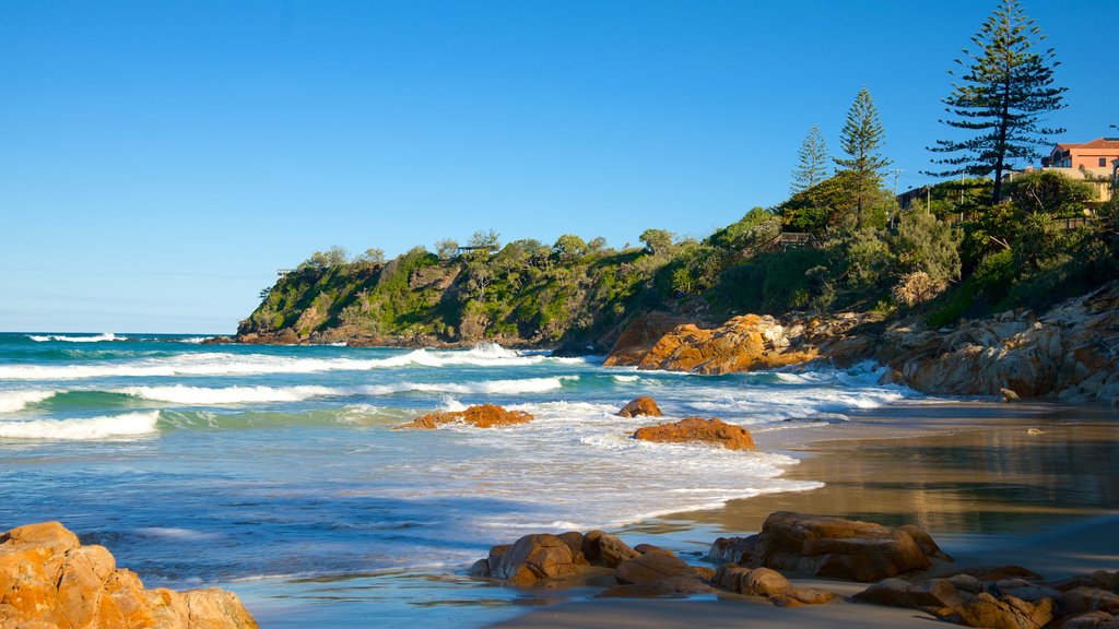 Coolum Beach showing a sandy beach and rocky coastline