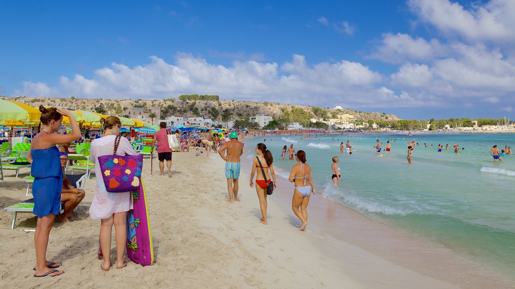 San Vito Lo Capo which includes a sandy beach and swimming as well as a large group of people