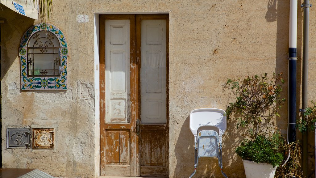 San Vito Lo Capo which includes heritage architecture, street scenes and a house