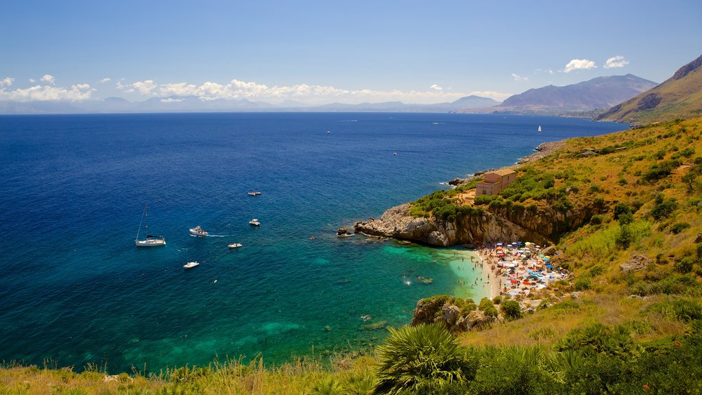 Zingaro Beach which includes landscape views, rugged coastline and a bay or harbor