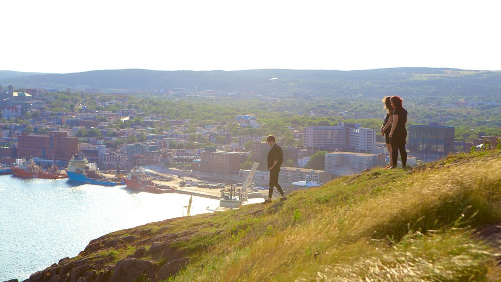 Signal Hill que incluye una ciudad y vista panorámica y también un pequeño grupo de personas