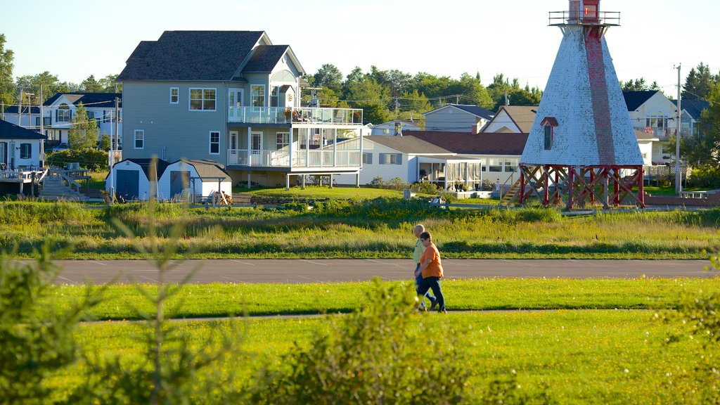 Parlee Beach Provincial Park which includes a house and a lighthouse