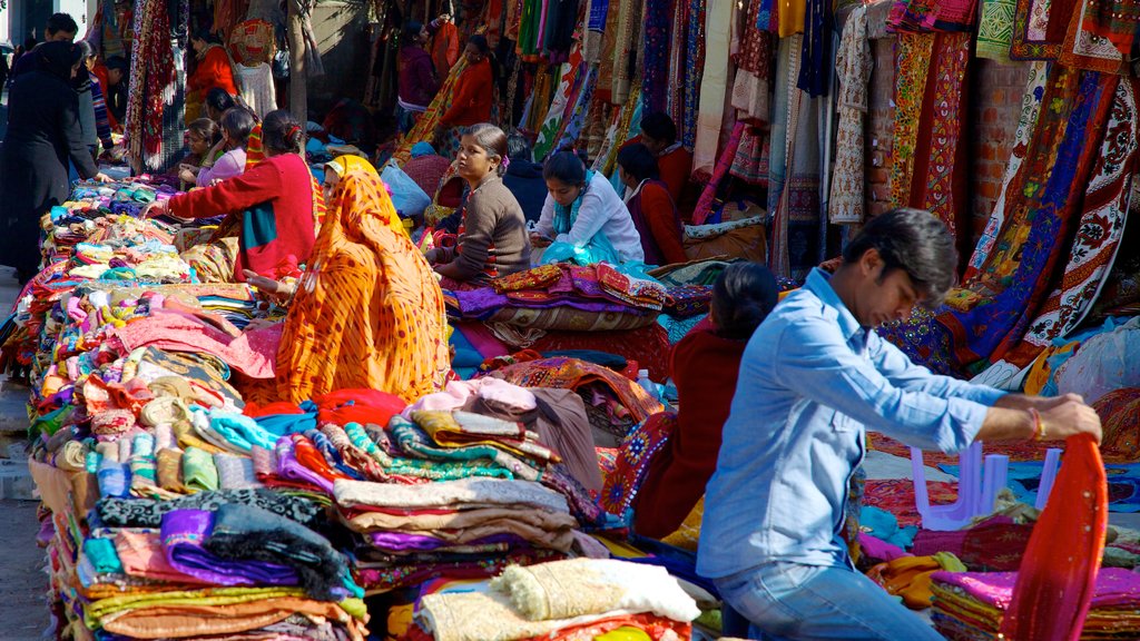 Delhi featuring markets and shopping as well as a small group of people