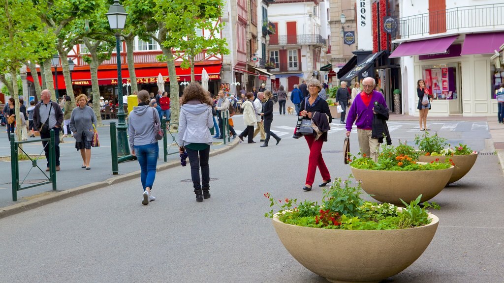 Saint-Jean-de-Luz showing hiking or walking and a square or plaza as well as a large group of people