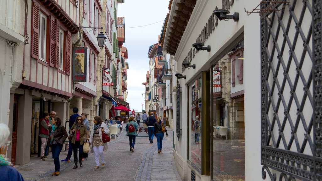 Saint-Jean-de-Luz showing a city and a small town or village as well as a large group of people