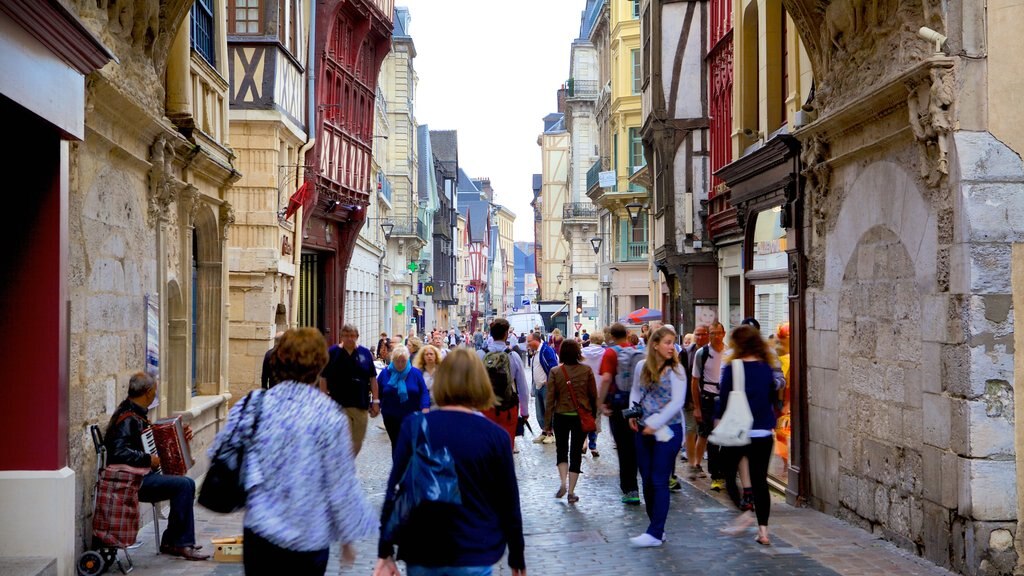 Gros Horloge showing street scenes as well as a large group of people