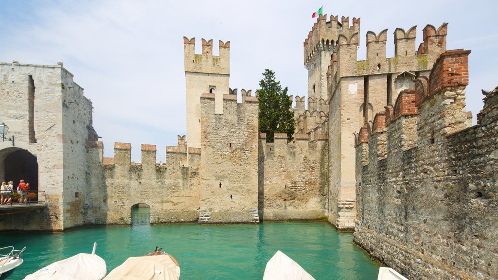 Scaliger Castle featuring château or palace, heritage elements and a lake or waterhole