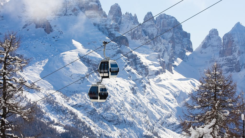 Madonna di Campiglio som omfatter bjerge, en kabinelift og sne