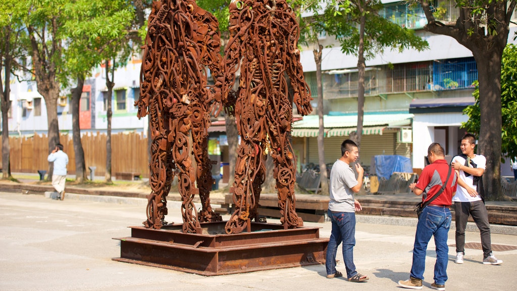 Pier-2 Art Center showing a statue or sculpture and outdoor art as well as a small group of people