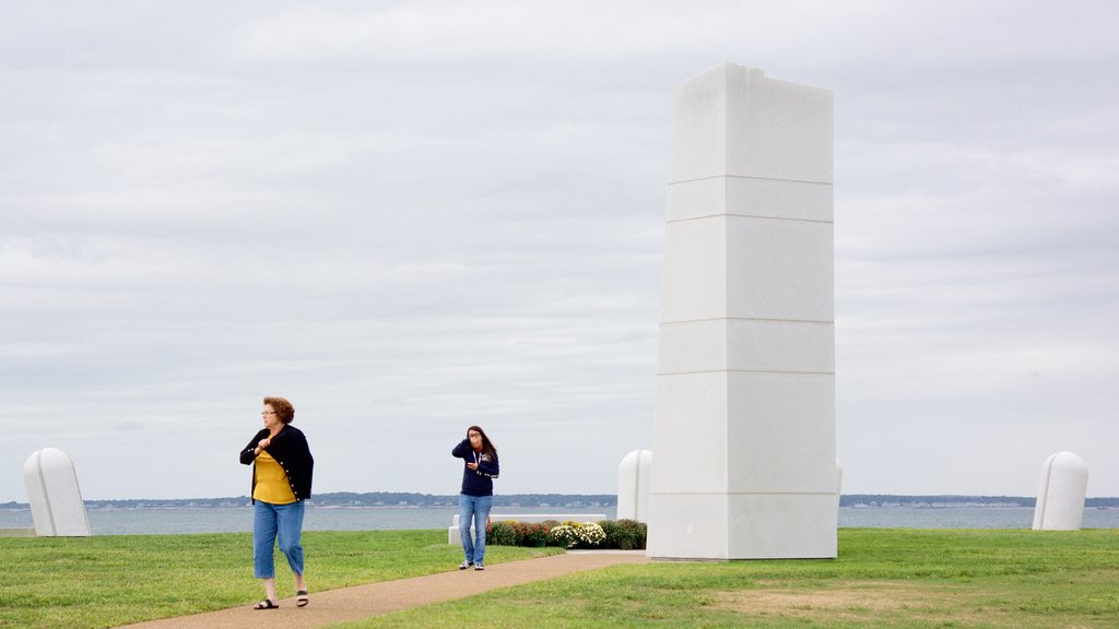 Brenton Point State Park og byder på et monument og udsigt over kystområde såvel som en lille gruppe mennesker