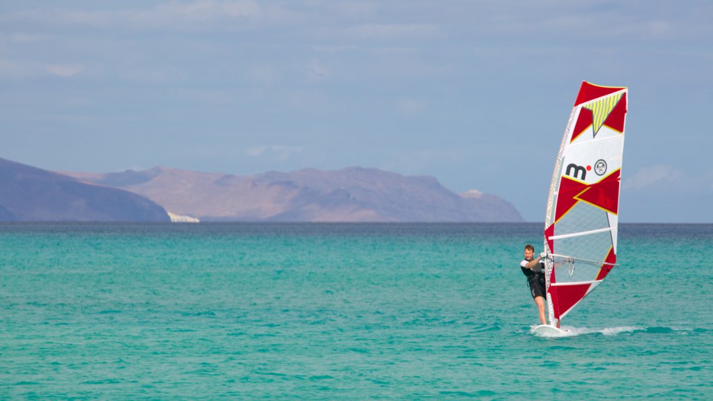 Sotavento de Jandia Beach showing general coastal views and windsurfing as well as an individual male