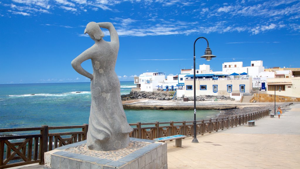 El Cotillo featuring a coastal town, a statue or sculpture and general coastal views