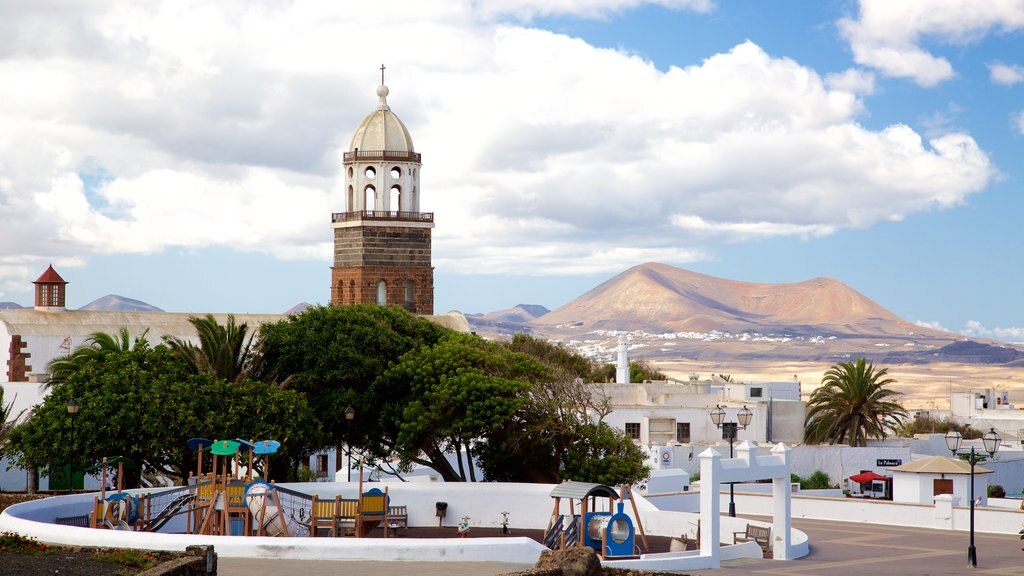 Teguise featuring a playground, mountains and a small town or village