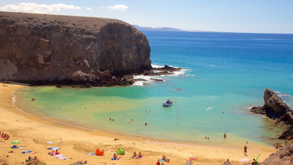 Papagayo Beach showing general coastal views, rocky coastline and a sandy beach