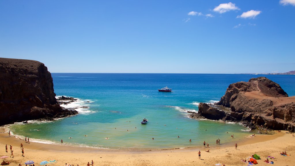 Papagayo Beach showing rocky coastline, a sandy beach and general coastal views