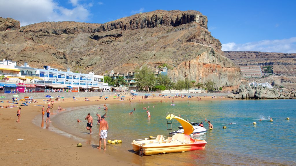 Playa de Mogan som viser en kystby, bådsejlads og svømning