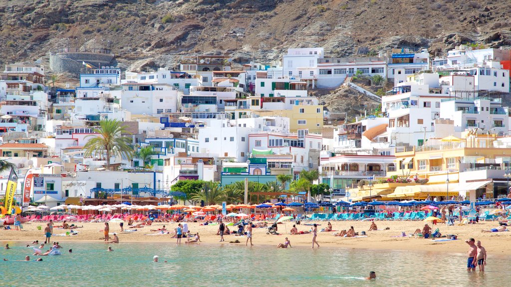 Playa de Mogan which includes a beach, swimming and a coastal town