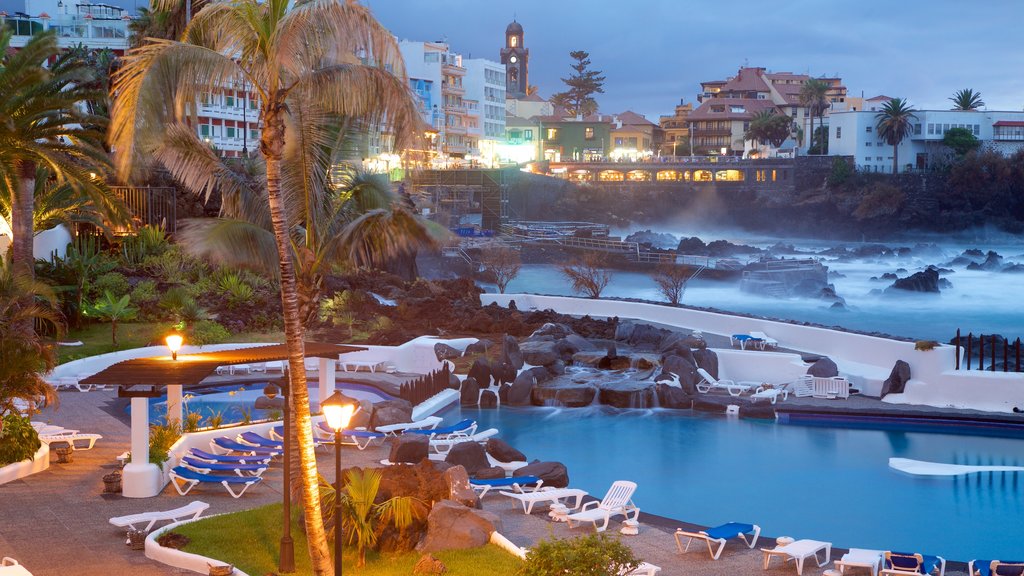 Puerto de la Cruz showing a coastal town, a luxury hotel or resort and a pool