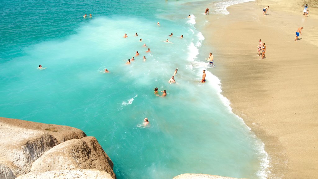 Del Duque Beach which includes swimming, a sandy beach and general coastal views