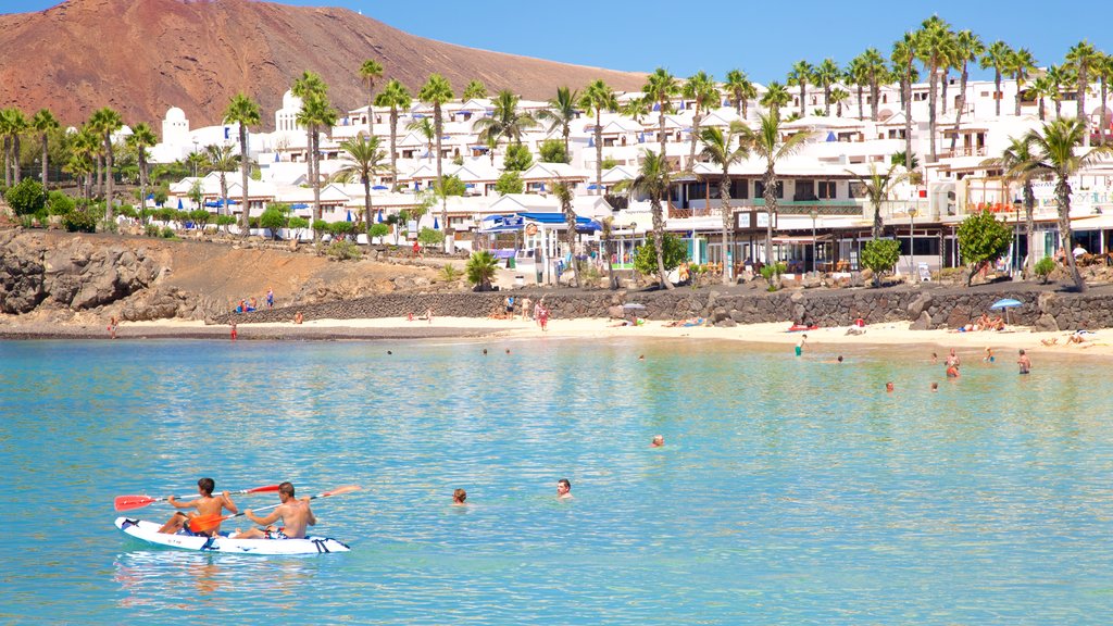 Playa Blanca showing a coastal town, kayaking or canoeing and swimming