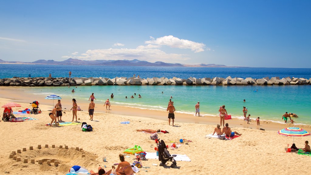 Playa Blanca which includes a beach, swimming and general coastal views