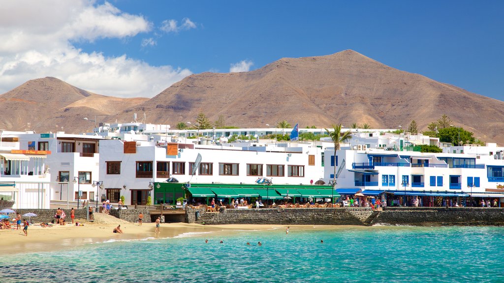 Playa Blanca showing a coastal town, general coastal views and a beach