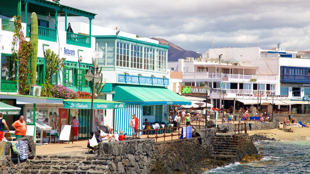 Playa Blanca showing a sandy beach and a coastal town