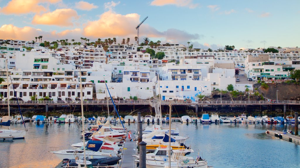 Puerto del Carmen which includes a bay or harbour, a coastal town and boating