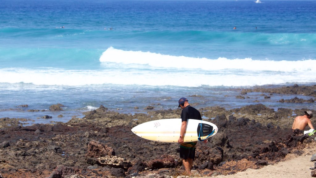 Playa de las Americas which includes rocky coastline, waves and surfing