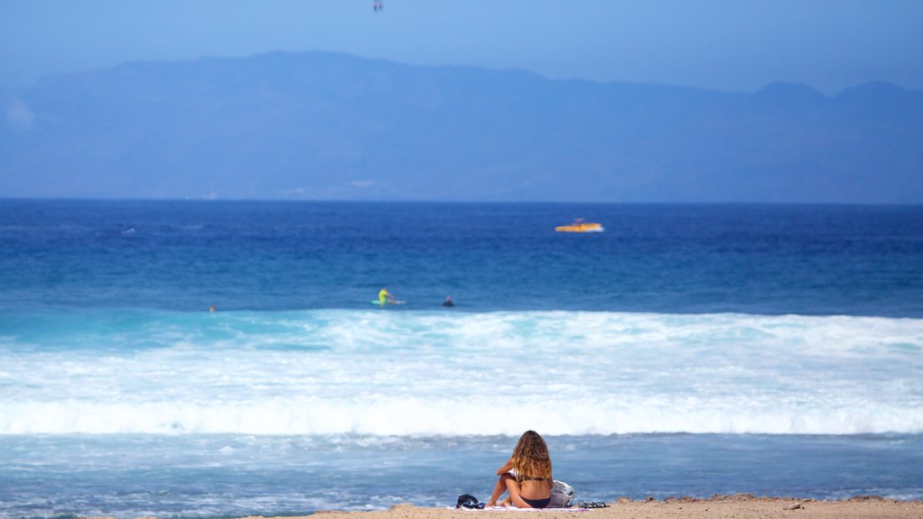 Las Americas Beach showing kayaking or canoeing and general coastal views as well as an individual female