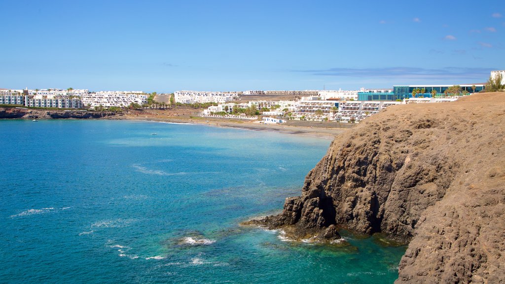 Playa de Papagayo que incluye costa rocosa, vista general a la costa y una ciudad costera