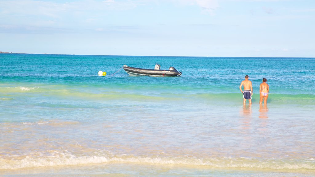 Corralejo Beach showing general coastal views and a sandy beach as well as a couple