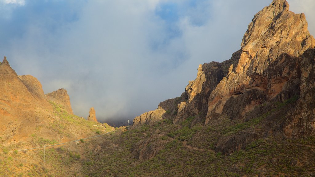 Roque Nublo showing mist or fog and mountains