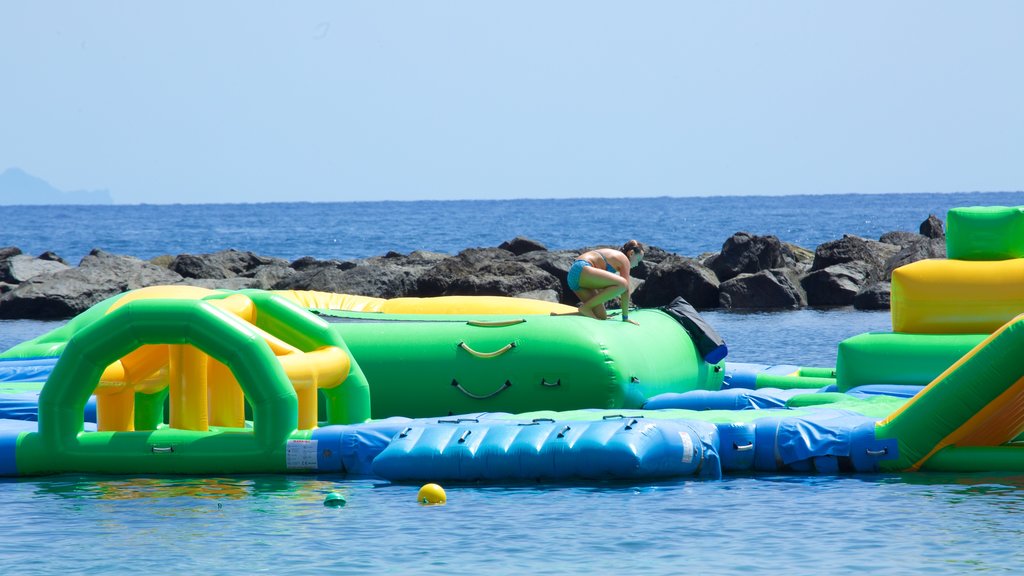 Teresitas Beach showing general coastal views and a playground as well as an individual female