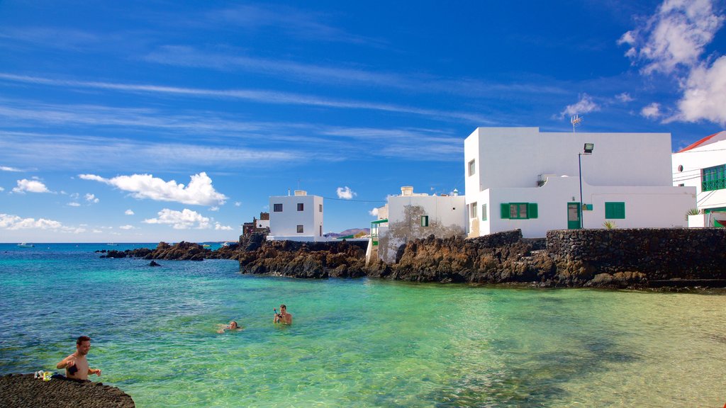 Lanzarote featuring a coastal town, rocky coastline and general coastal views