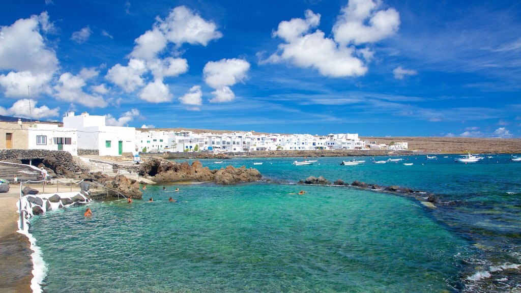 Lanzarote showing rocky coastline, a coastal town and general coastal views