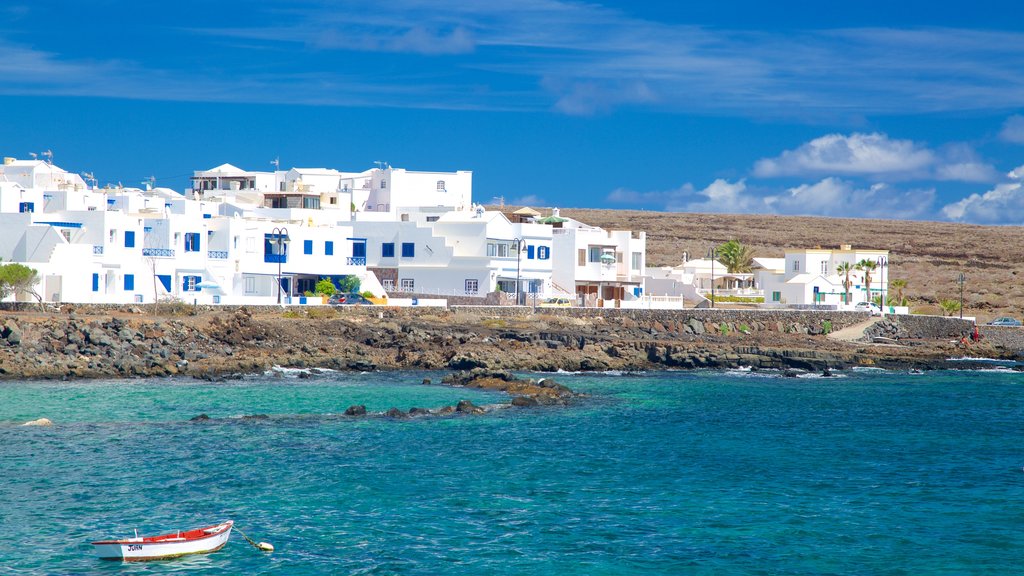 Lanzarote featuring a coastal town, rugged coastline and general coastal views