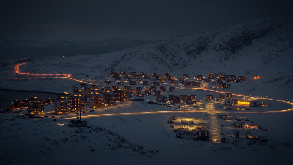 Nuuk which includes night scenes, a city and snow