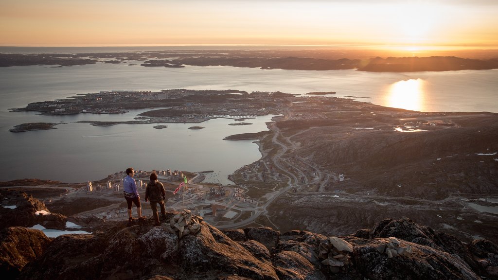 Nuuk which includes a lake or waterhole, a sunset and a city