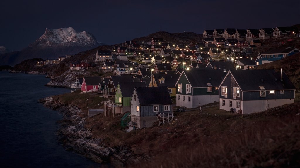 Nuuk which includes a small town or village, mountains and night scenes