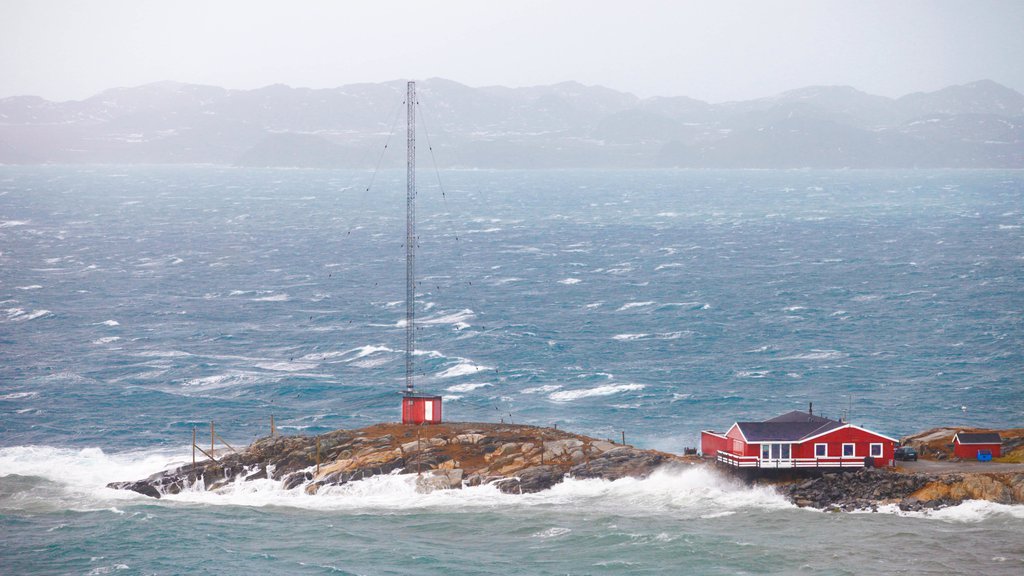 Nuuk showing rocky coastline, surf and a house