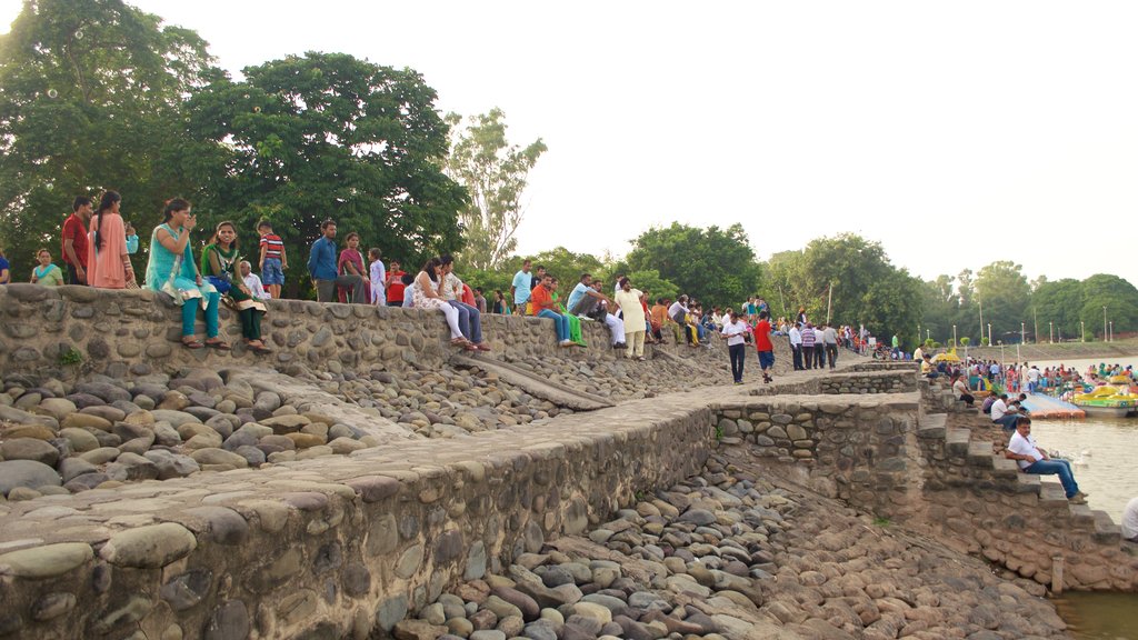 Sukhna Lake showing a lake or waterhole as well as a small group of people