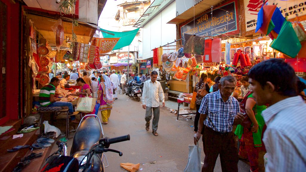 Manek Chowk featuring markets as well as a small group of people