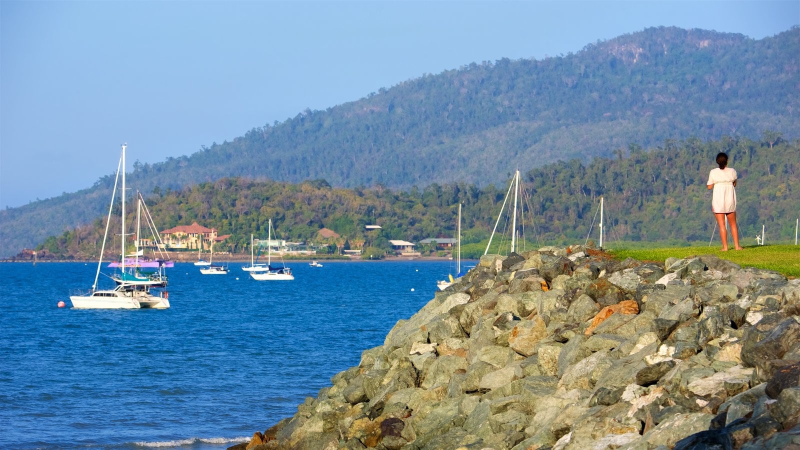 Airlie Beach which includes general coastal views and landscape views as well as an individual female