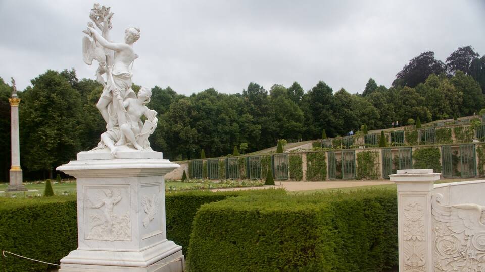 Sanssouci-paladset som omfatter en statue eller en skulptur og et slot