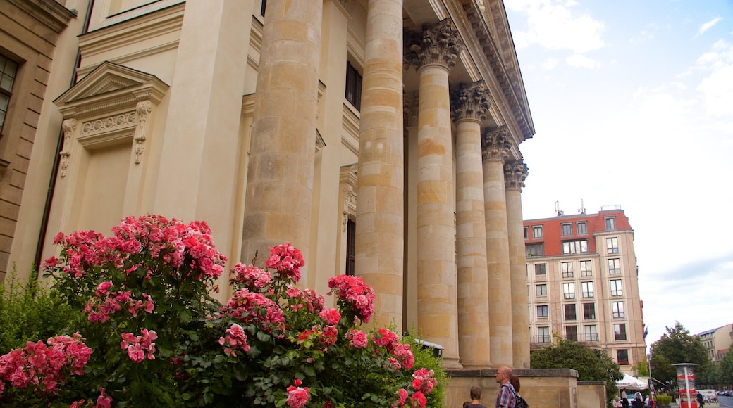 Berlin showing a church or cathedral, heritage elements and flowers