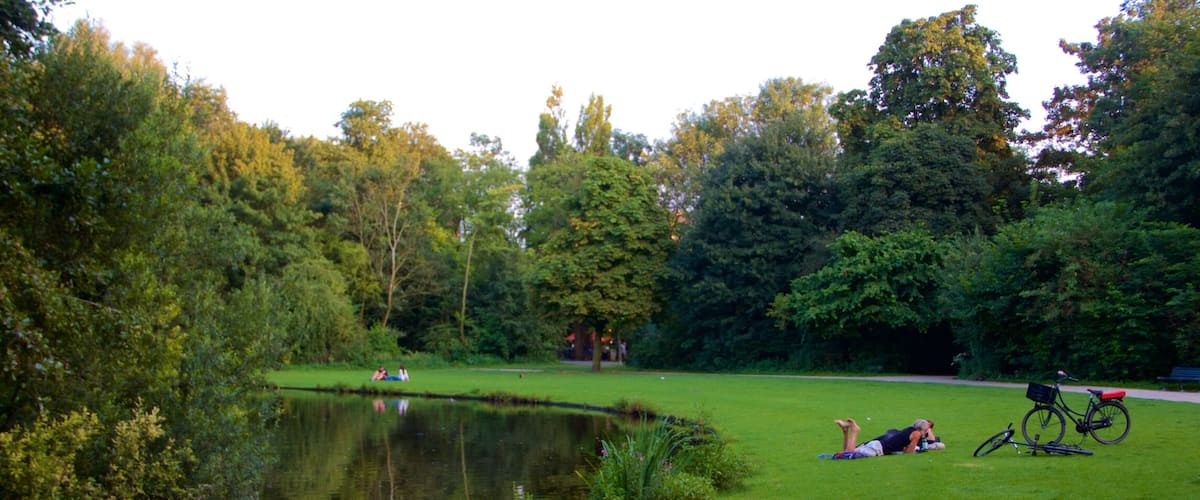 Vondelpark which includes a pond and a garden as well as a couple